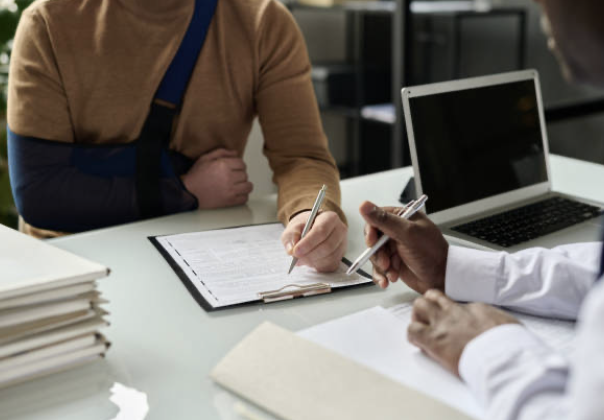 A claimant reviewing disability claim documents with a representative